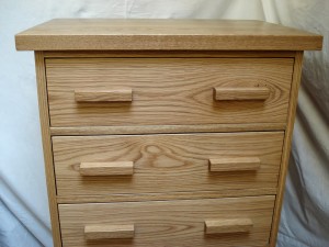 Tall chest of drawers in oak