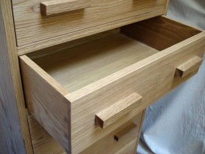 Tall chest of drawers in oak